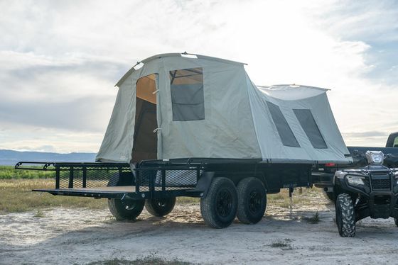 Jumping Jack tent trailer set up as a basecamp beside a pickup truck.