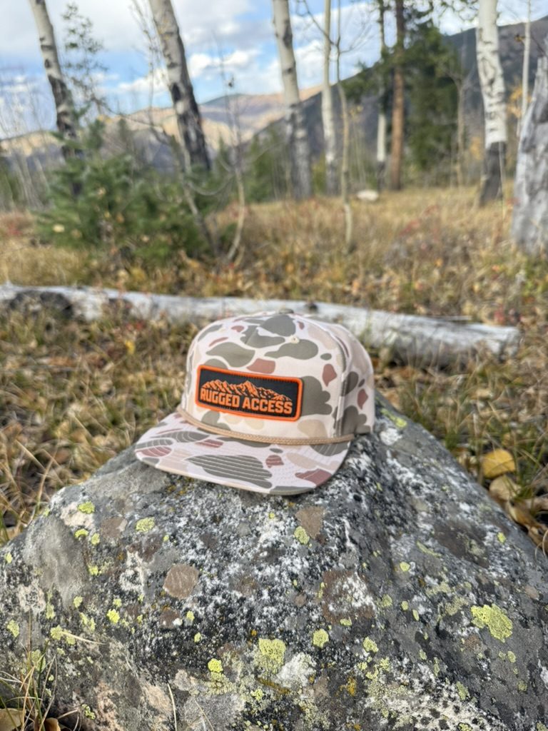Desert duck camo Rugged Access rope hat on a boulder in an aspen grove.